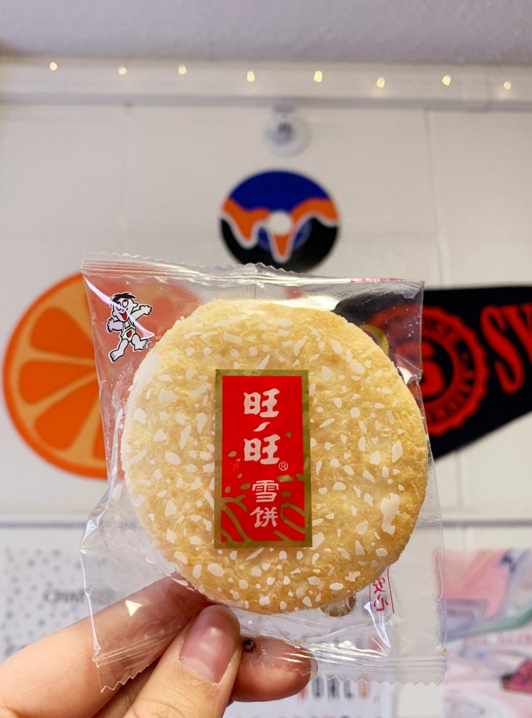 Rice cracker in packaging held by a few fingers